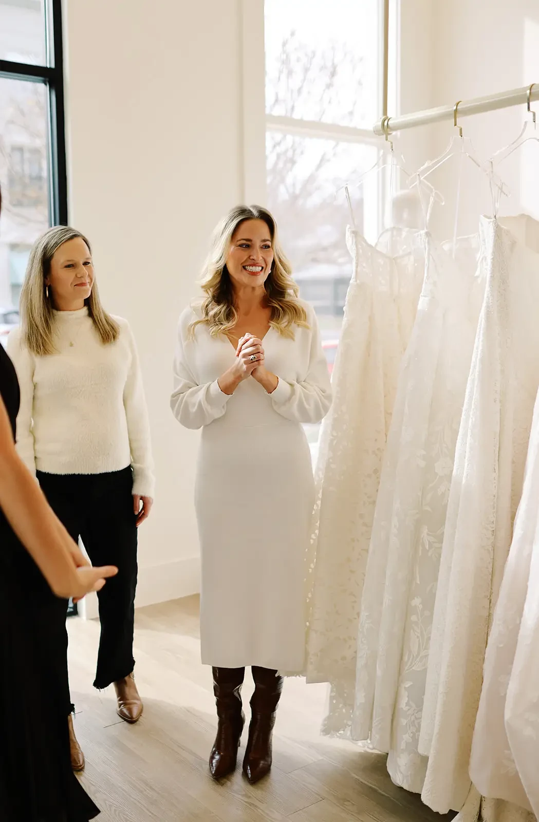 image shows woman smiling while shopping for her wedding dress at ladies of lineage