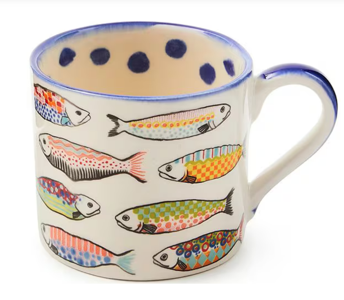 Image shows a colorful Mackenzie-Childs mug with whimsical fish illustrations.