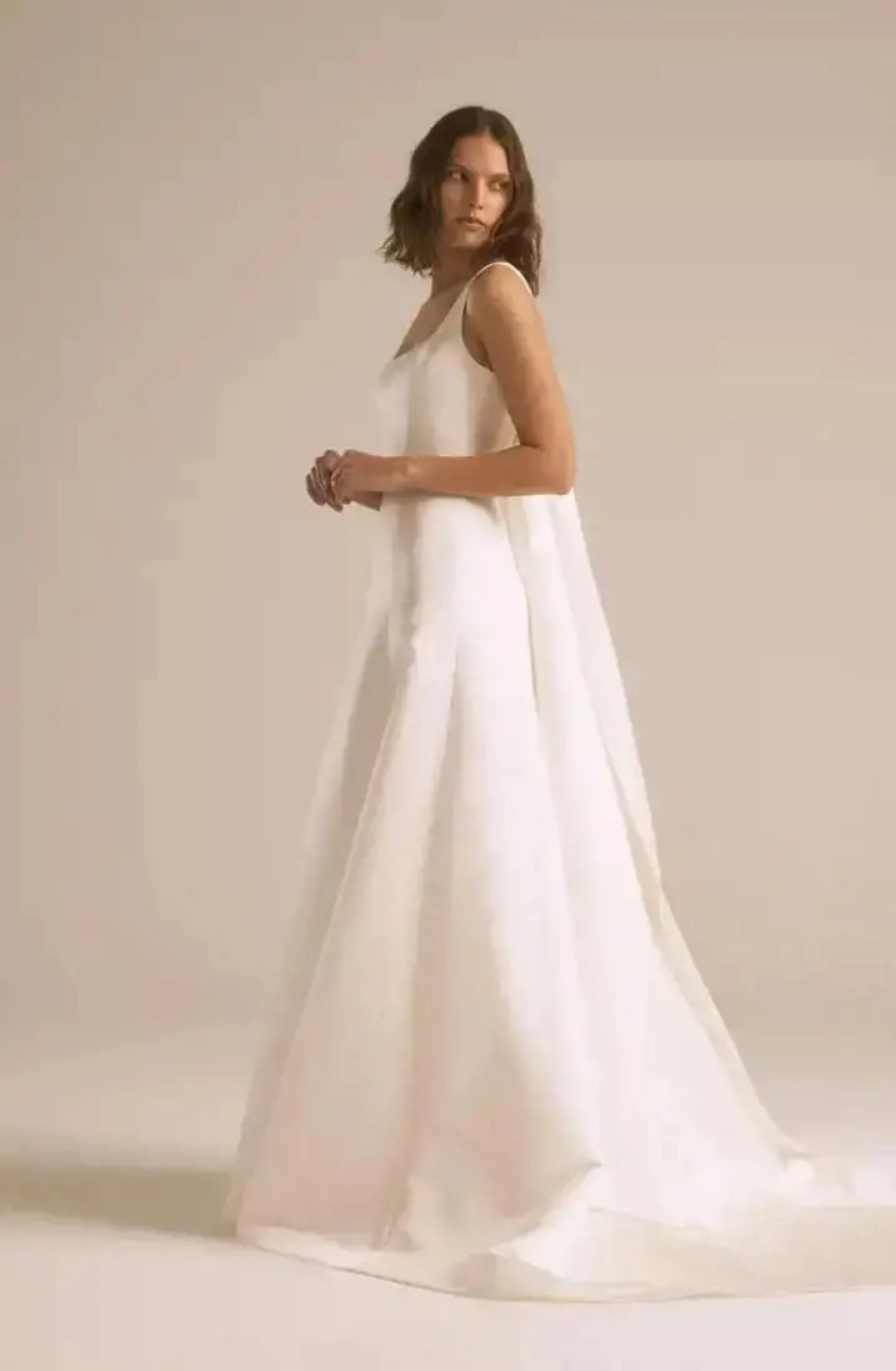 Model is wearing a sleeveless a-line wedding dress by nouvelle by amsale