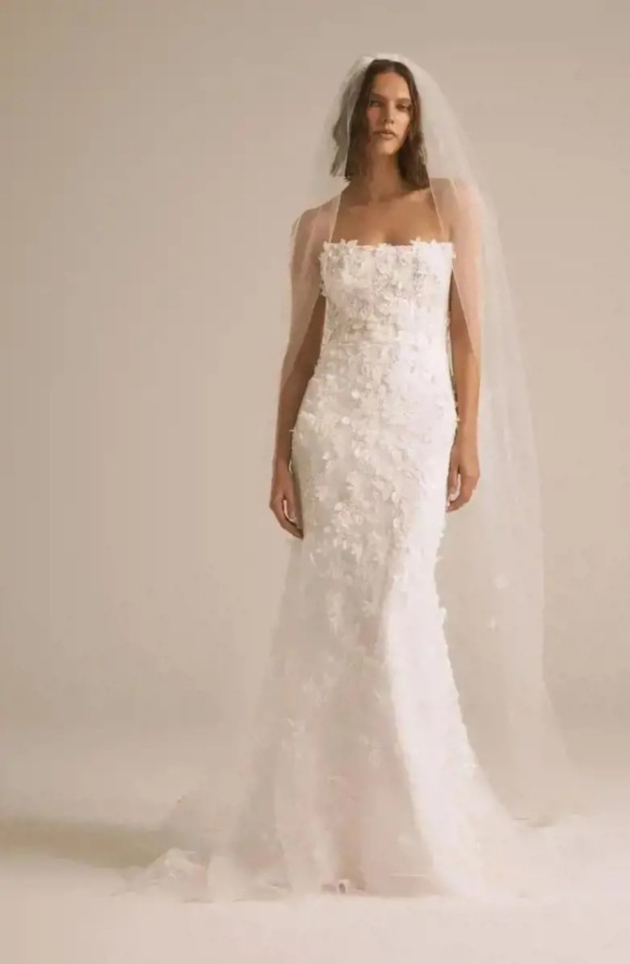 Model is wearing a strapless fit and flare wedding gown with 3D floral texture by nouvelle by amsale