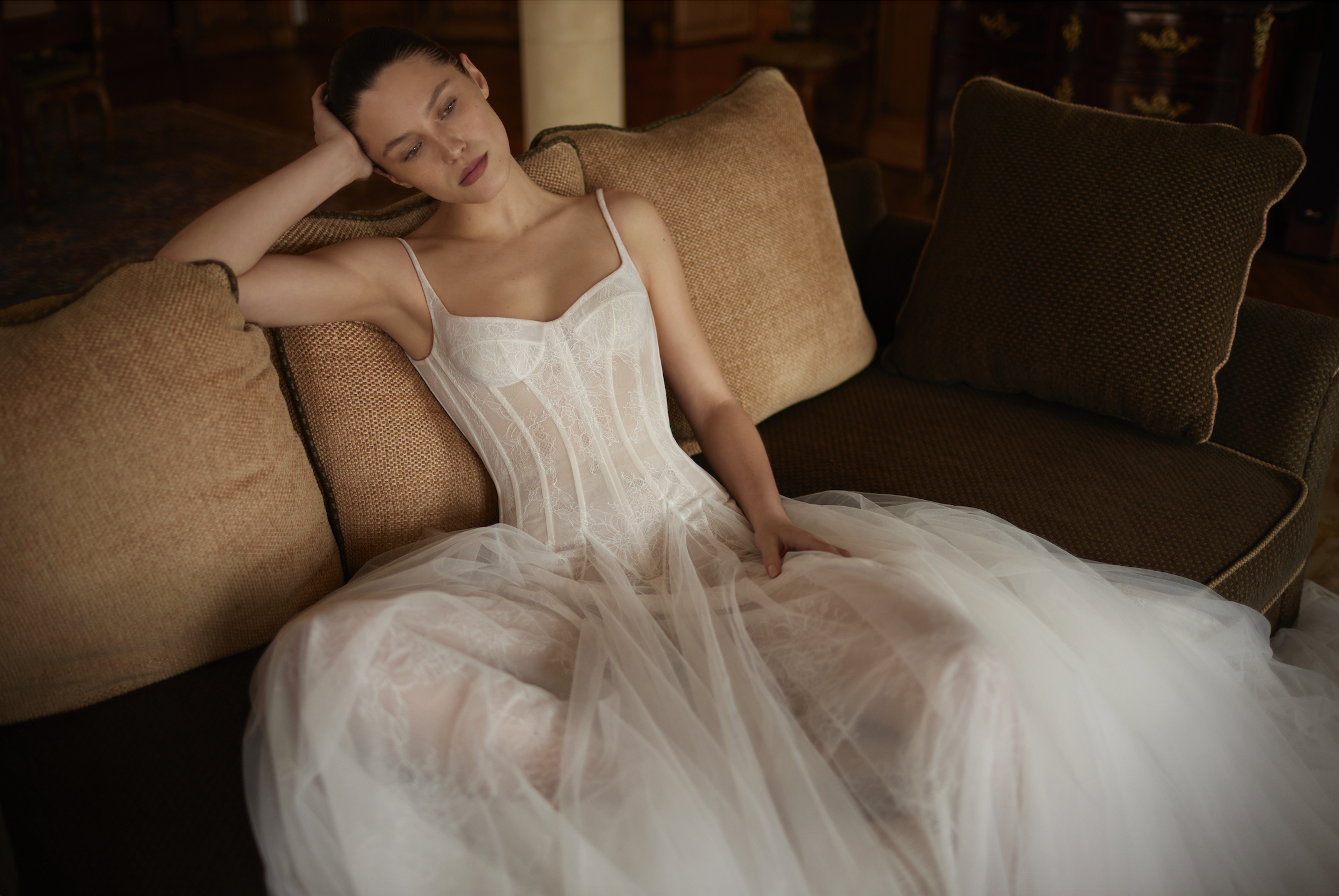 model is wearing a sleeveless wedding dress by dana harel